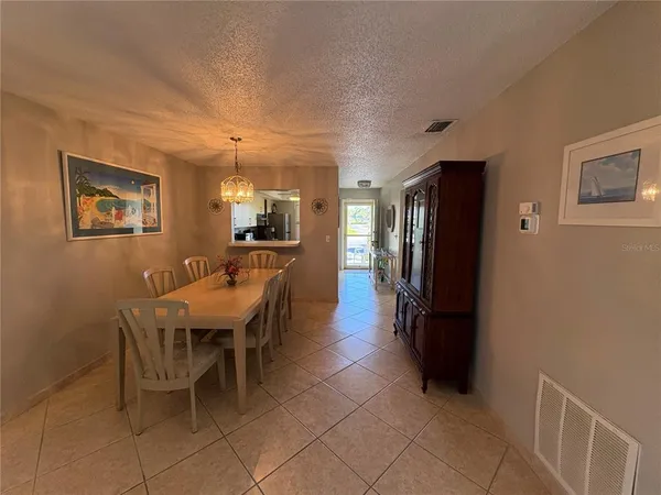 a dining room with furniture and a kitchen