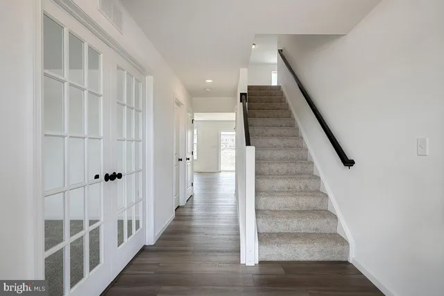 a view of staircase with white walls and stairs