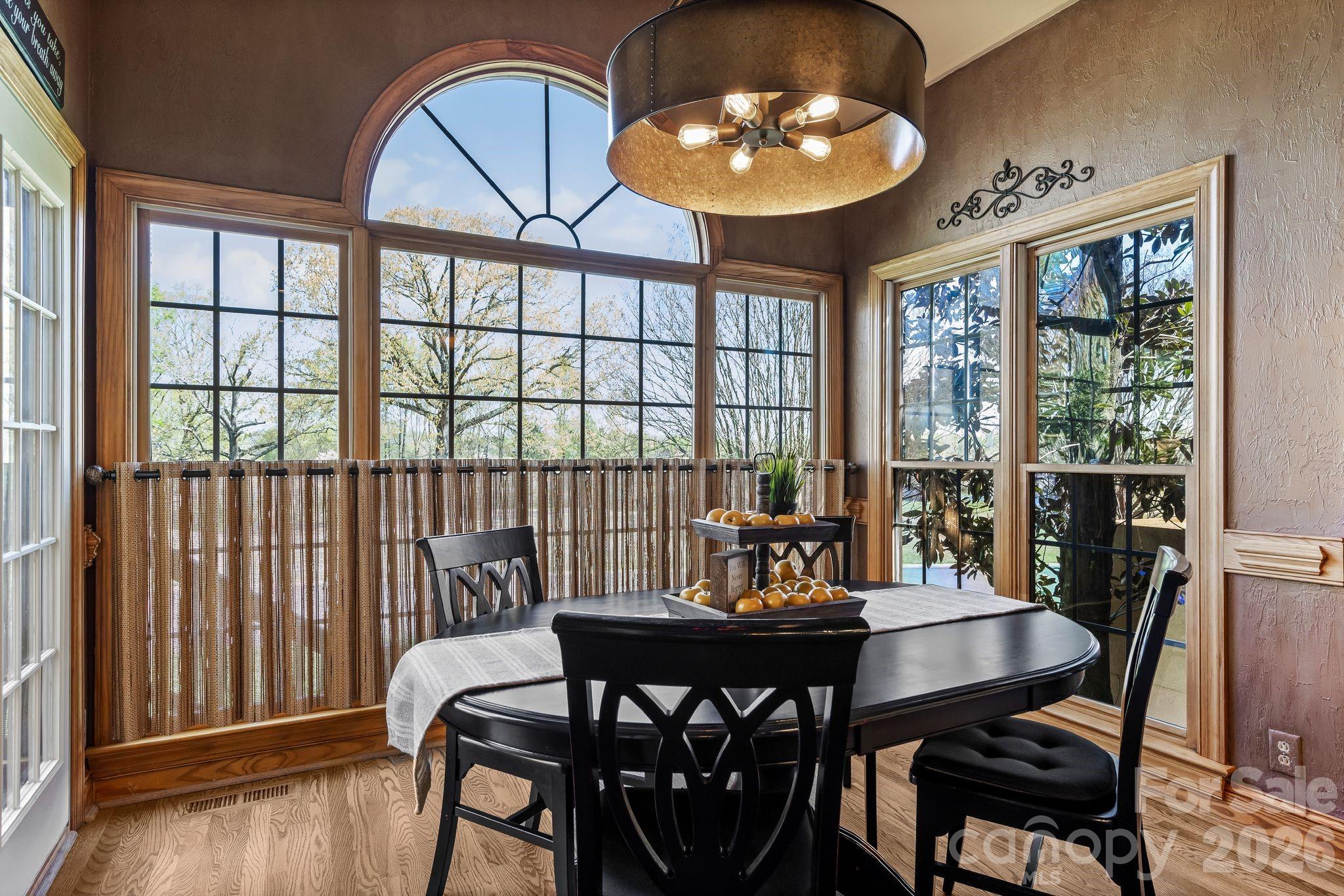 3530 Cardiff Lane Matthews, NC 28104 - Photo 14 of 39 a view of a dining room with furniture window and wooden floor