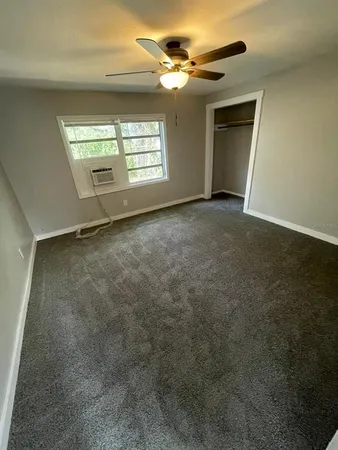 a bathroom with a tub a sink a window and a shower