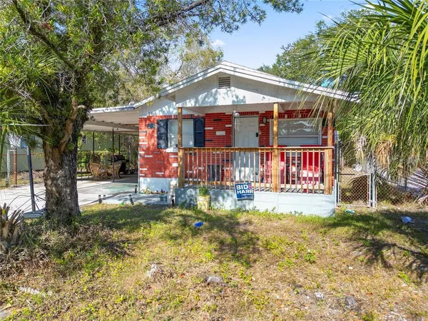 a front view of a house with a yard table and chairs