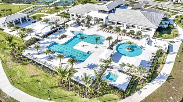 a view of a swimming pool and lounge chairs