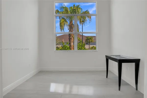 an empty room with sliding door and wooden floor