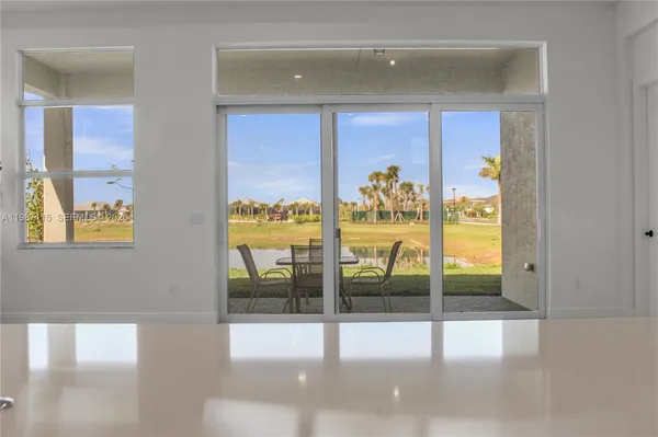 an empty room with window and wooden floor