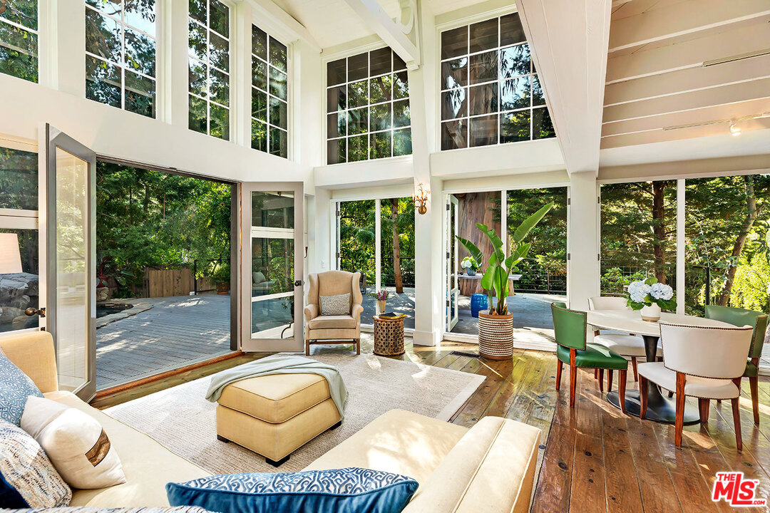 689 Brooktree Road Santa Monica, CA 90402 - Photo 12 of 32 a living room with furniture and floor to ceiling windows