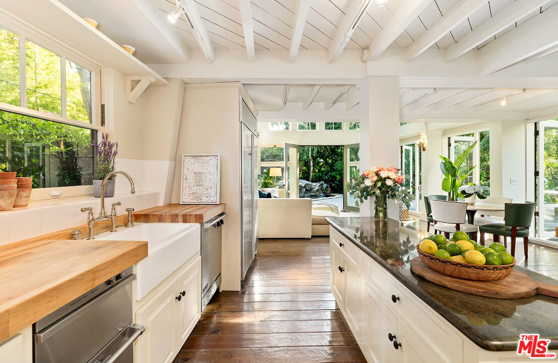 689 Brooktree Road Santa Monica, CA 90402 - Photo 18 of 32 a large white kitchen with a large window