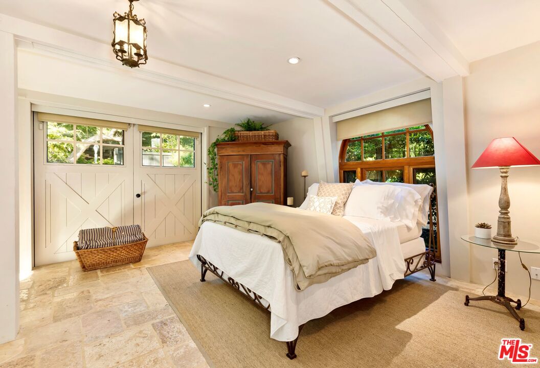 689 Brooktree Road Santa Monica, CA 90402 - Photo 20 of 32 a bedroom with a bed and window