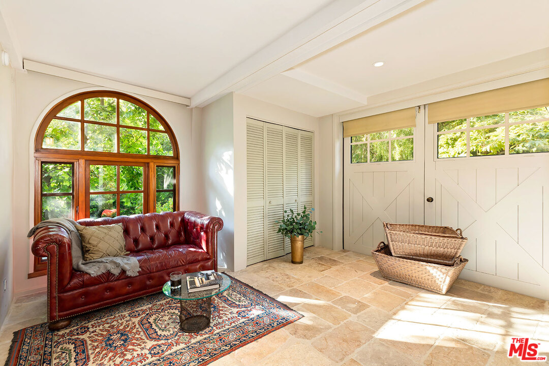 689 Brooktree Road Santa Monica, CA 90402 - Photo 21 of 32 a living room with furniture and a large window