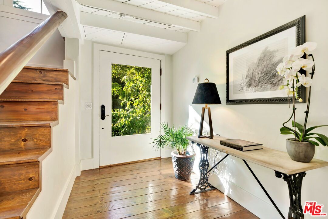 689 Brooktree Road Santa Monica, CA 90402 - Photo 23 of 32 a view of a hallway with furniture and a potted plant