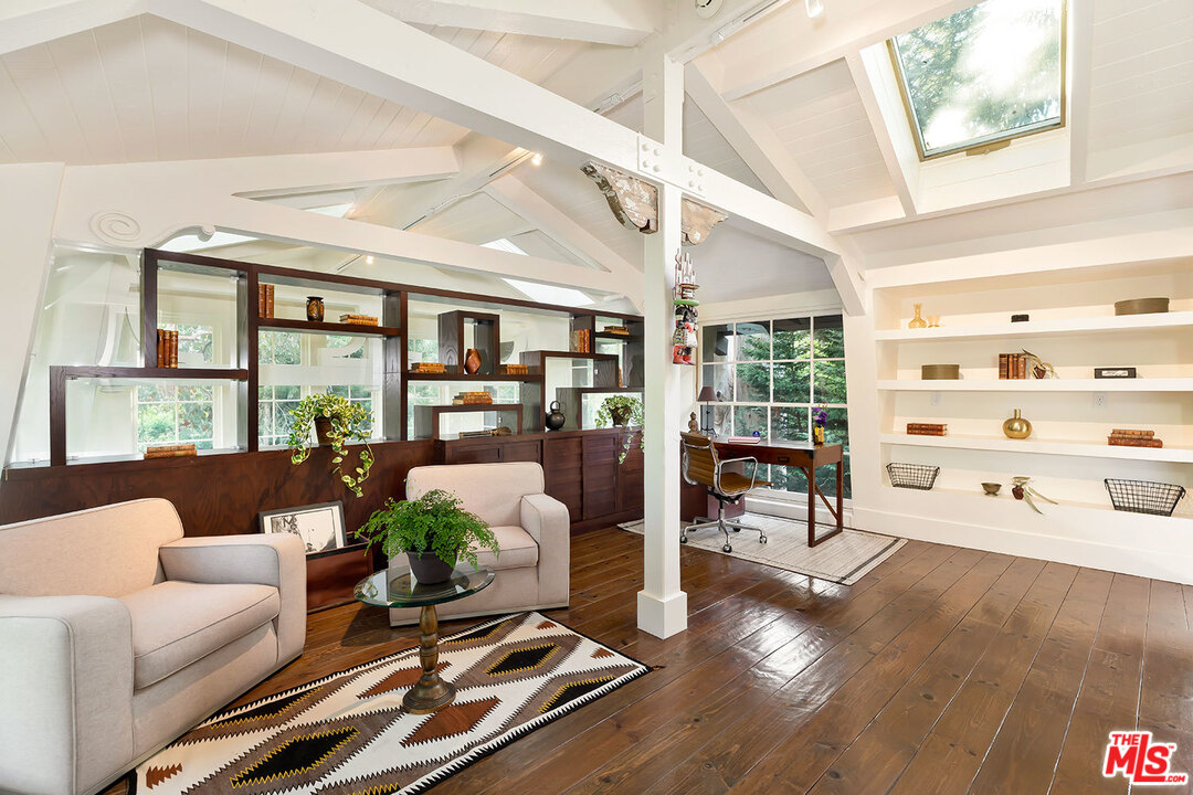 689 Brooktree Road Santa Monica, CA 90402 - Photo 27 of 32 a living room with furniture fireplace and a large window