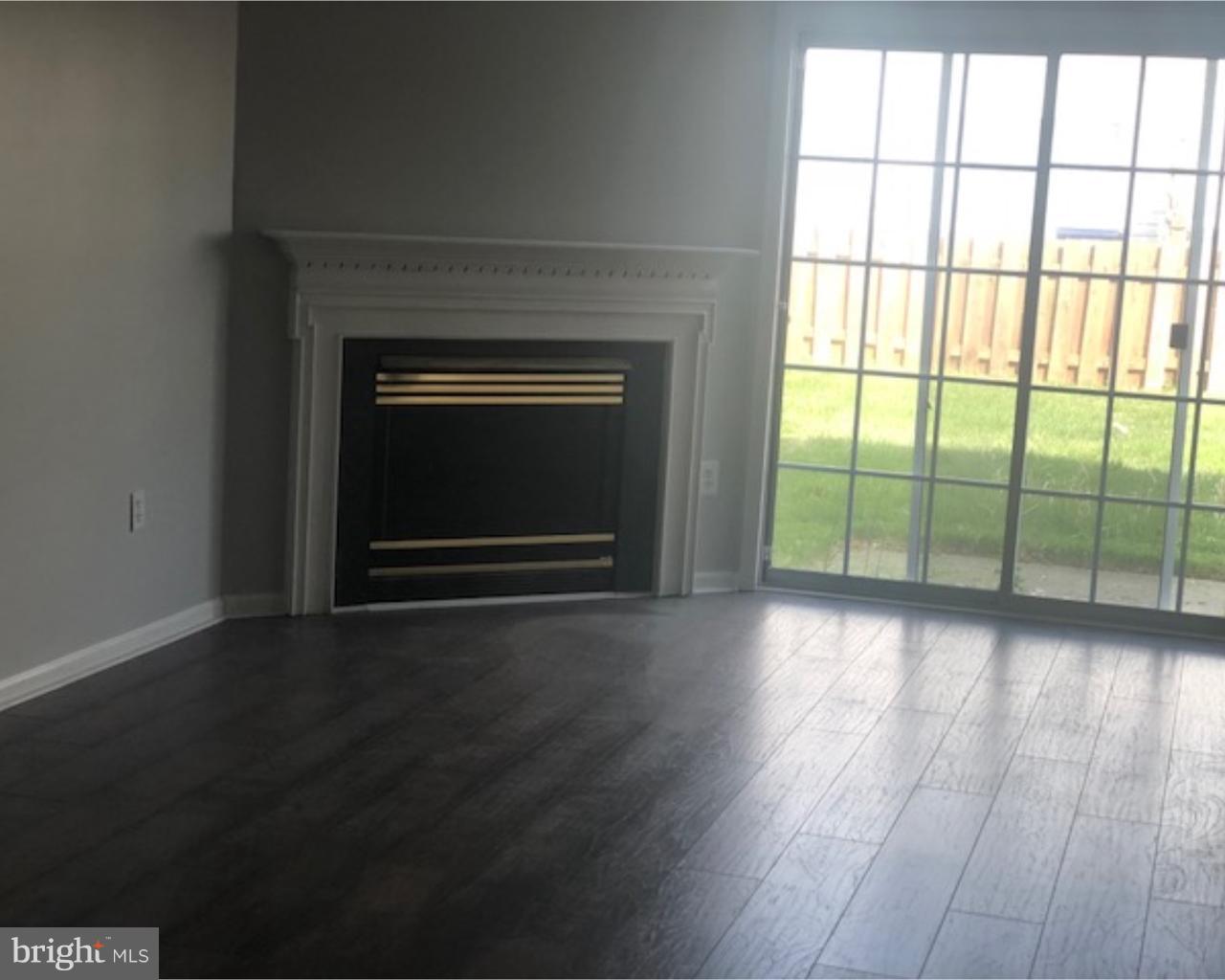 4 Sage Drive Lumberton, NJ 08048 - Photo 5 of 24 an empty room with wooden floor fireplace and windows