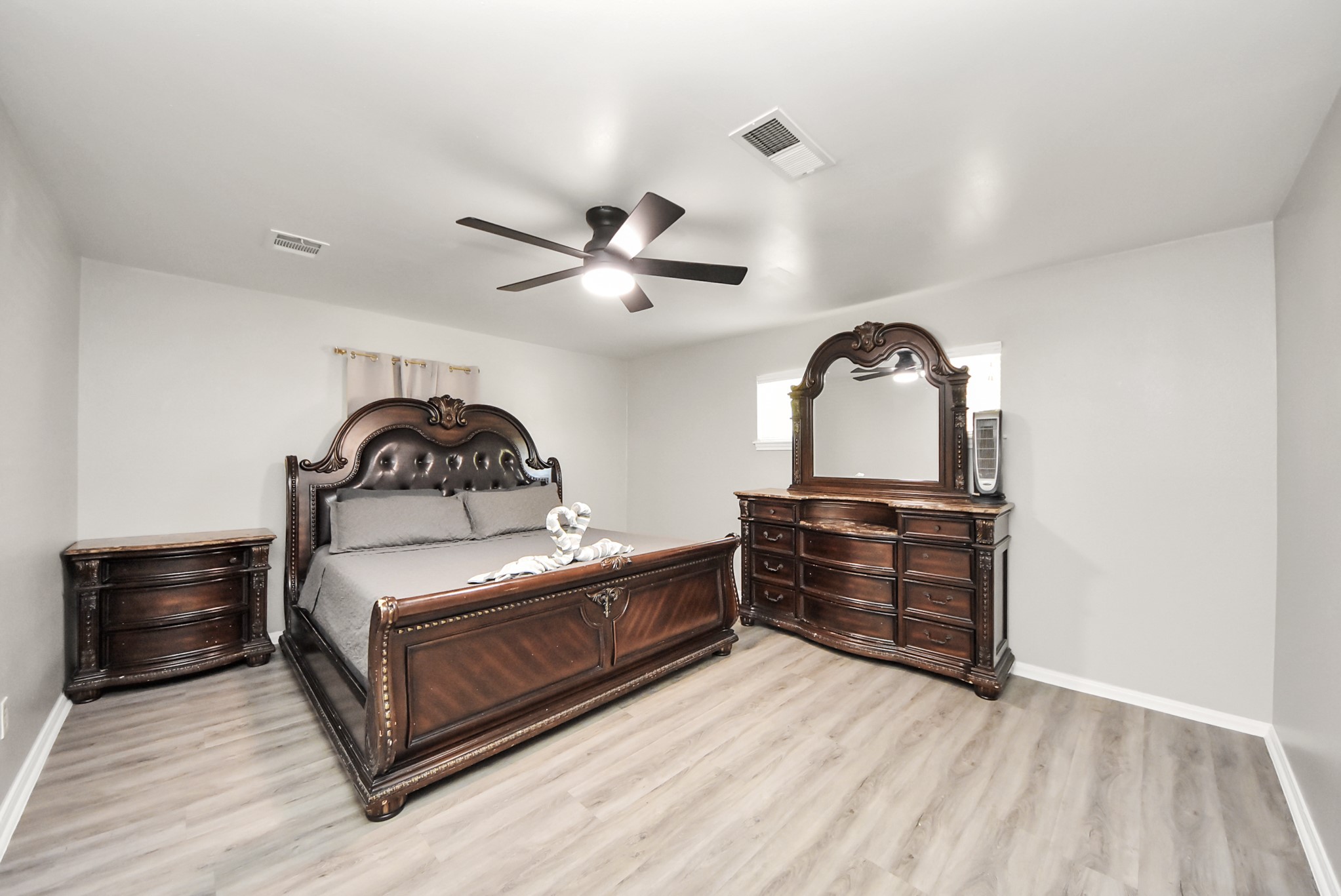 1011 Whitestone Lane Houston, TX 77073 - Photo 19 of 48 a bedroom with a bed and a dresser