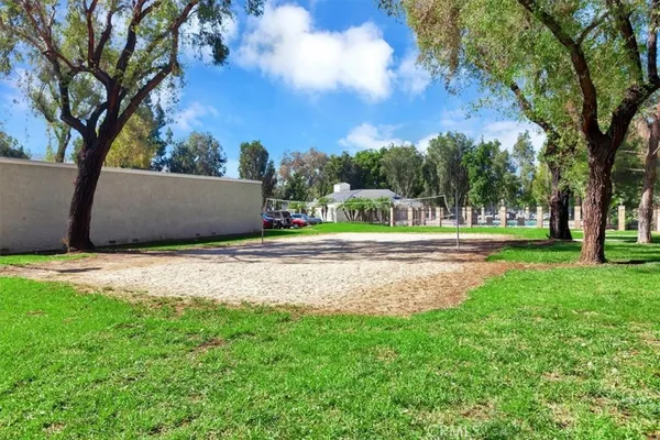 a front view of a house with garden and trees