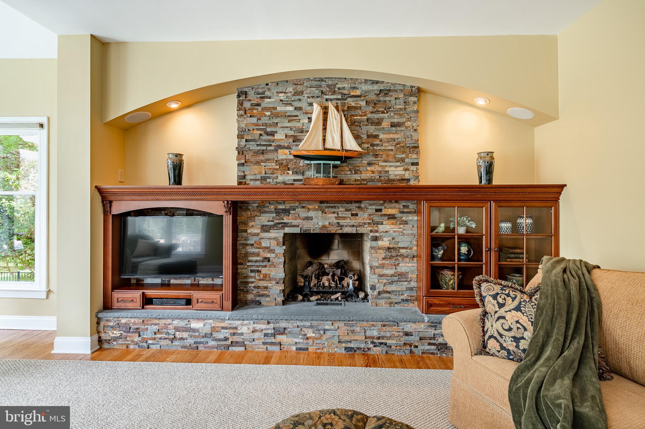 5 Country Run Thornton, PA 19373 - Photo 15 of 50 a living room with furniture a flat screen tv and a fireplace