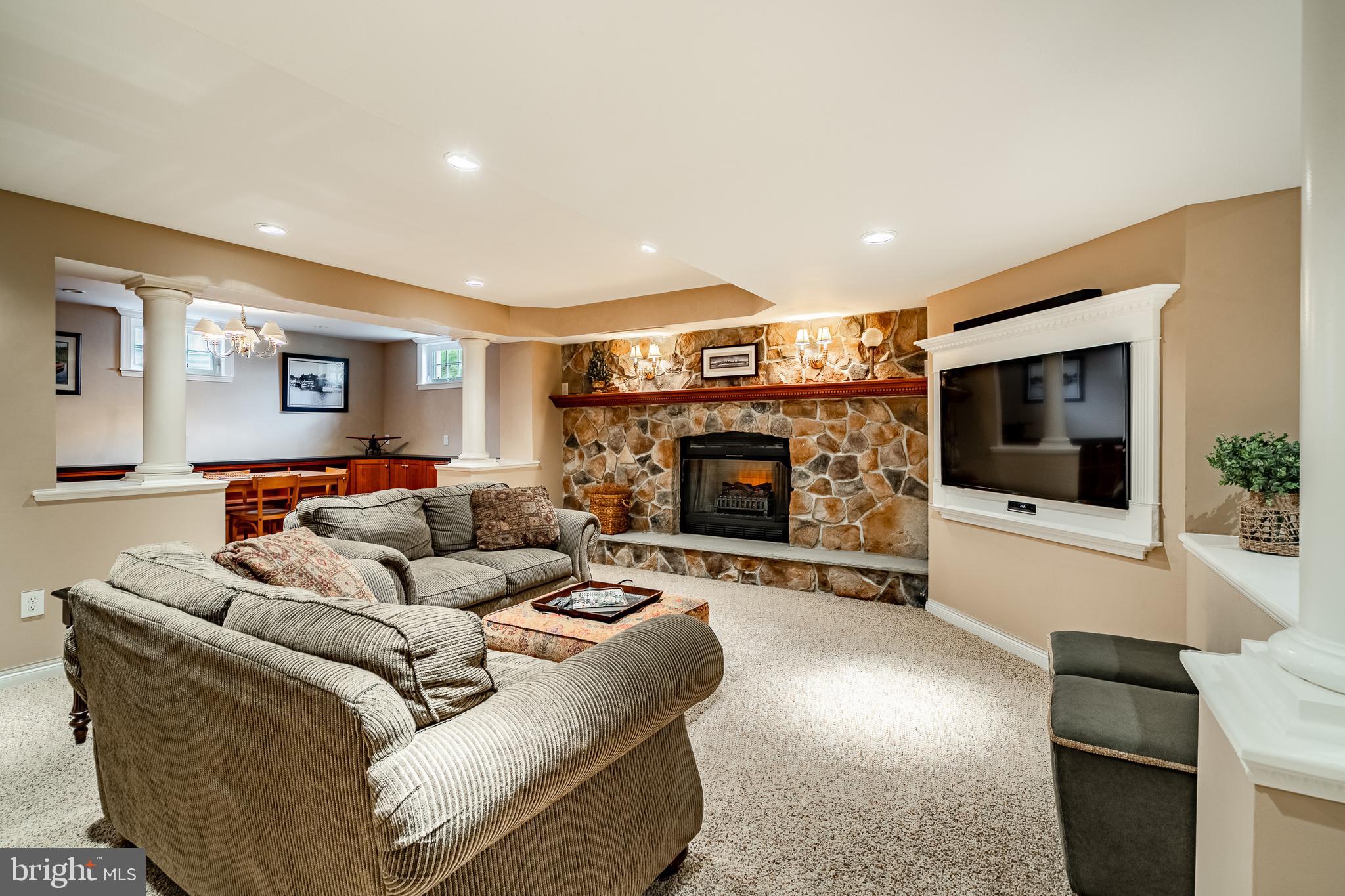5 Country Run Thornton, PA 19373 - Photo 32 of 50 a living room with furniture a flat screen tv and a fireplace