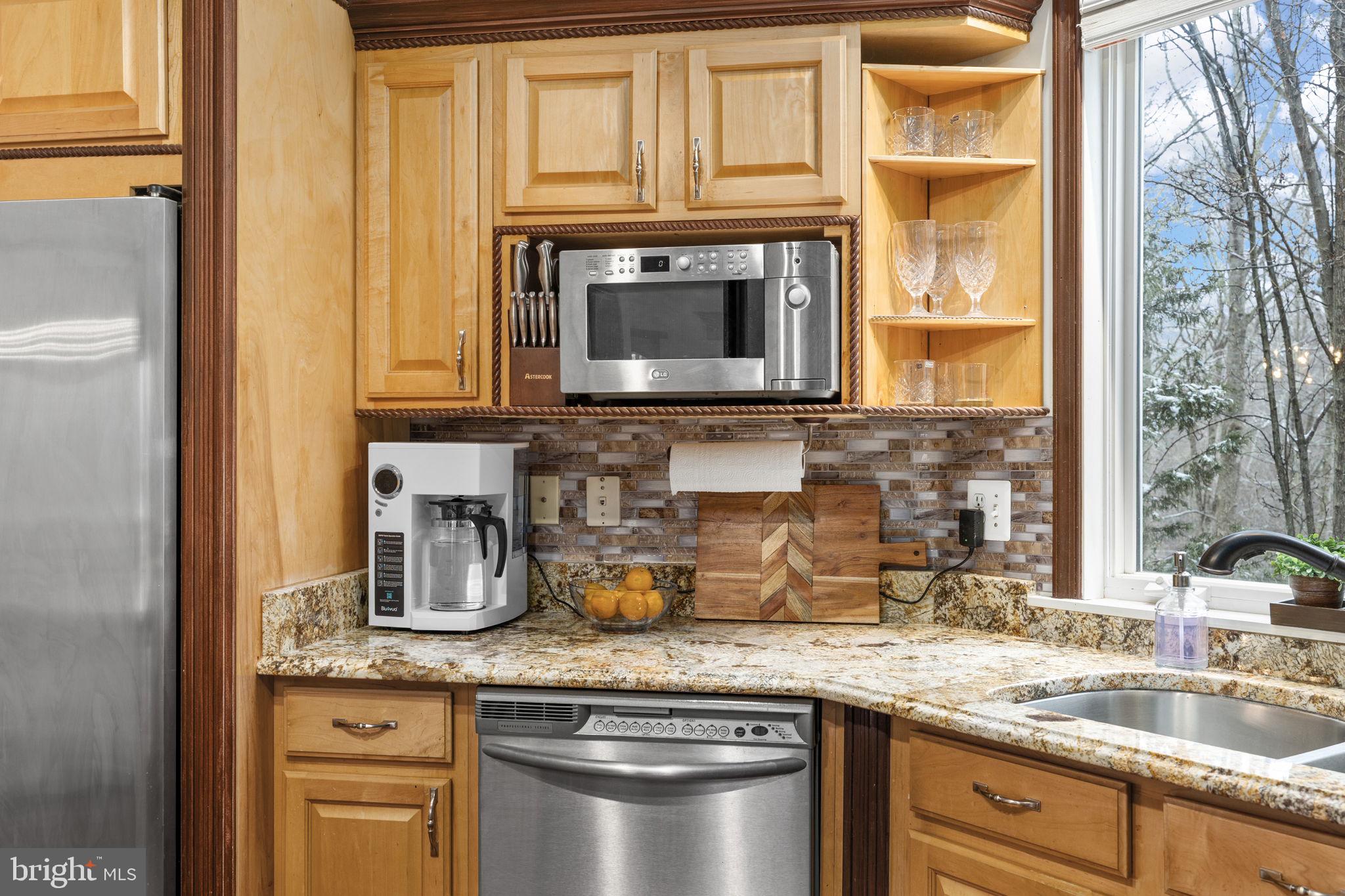 8701 Sinclair Mill Road Manassas, VA 20112 - Photo 28 of 130 a kitchen with granite countertop a sink a stove and cabinets
