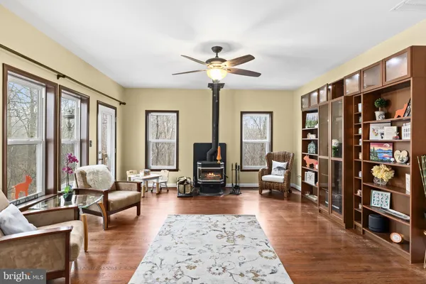 a bedroom with a bed a dresser and wooden floor