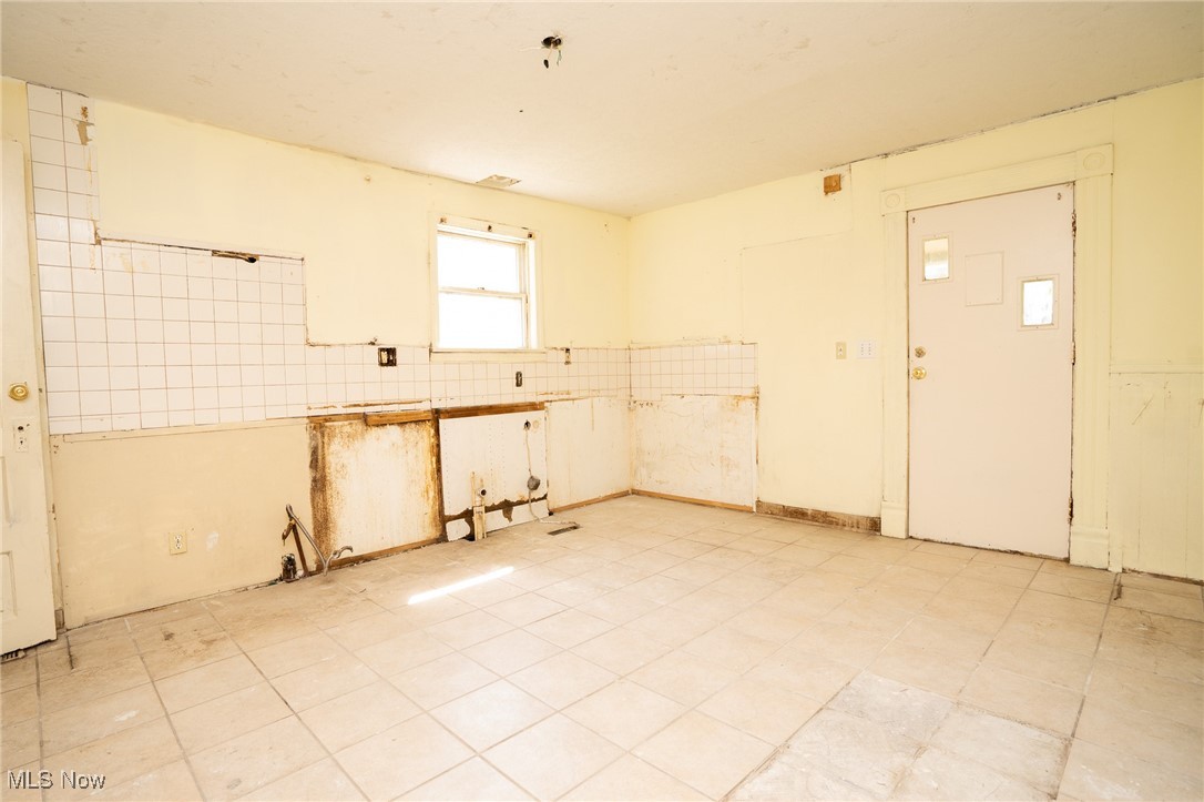 1720 Jacobs Road Youngstown, OH 44505 - Photo 11 of 18 Kitchen featuring tile walls and a wainscoted wall