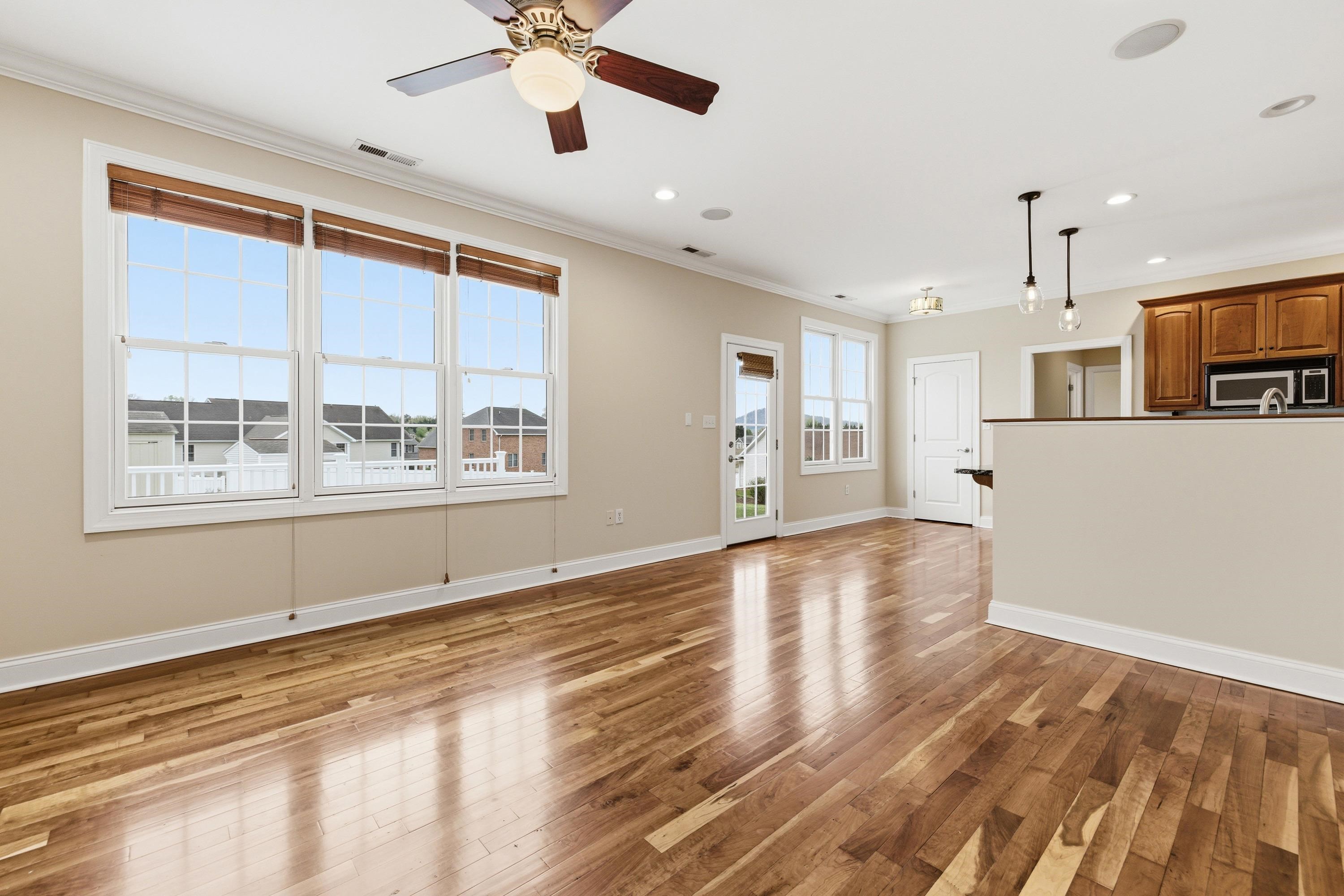 2625 Rising Rock Court Harrisonburg, VA 22802 - Photo 12 of 73 The living room space is large and offers hardwood flooring throughout, large windows allowing in an abundance of natural light, gas fireplace, and plenty of room for gathering with family and friends.