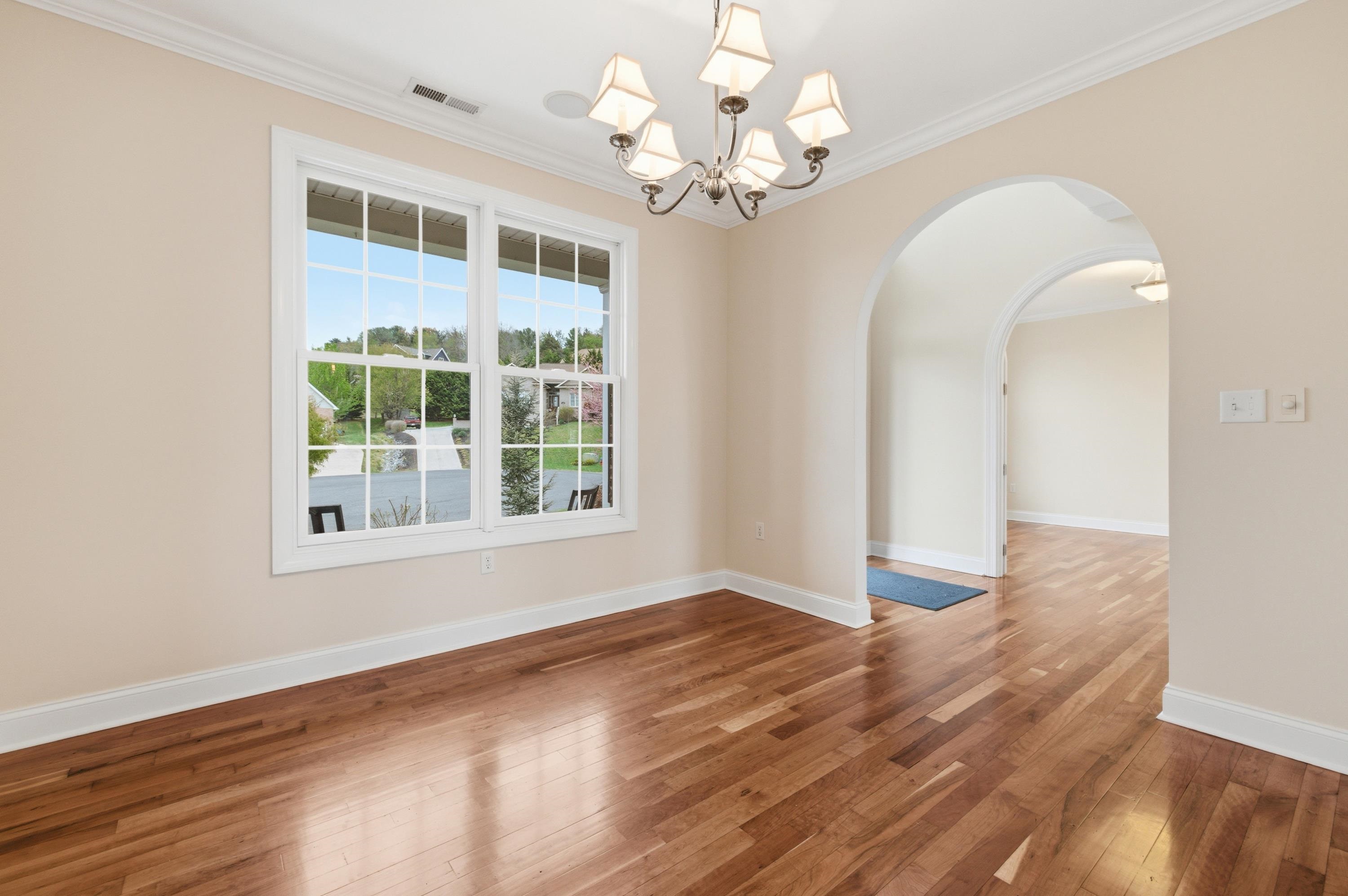 2625 Rising Rock Court Harrisonburg, VA 22802 - Photo 18 of 73 The dining room offers large windows throughout, chandelier, hardwood flooring throughout the space, and plenty of space for a table and chairs set.
