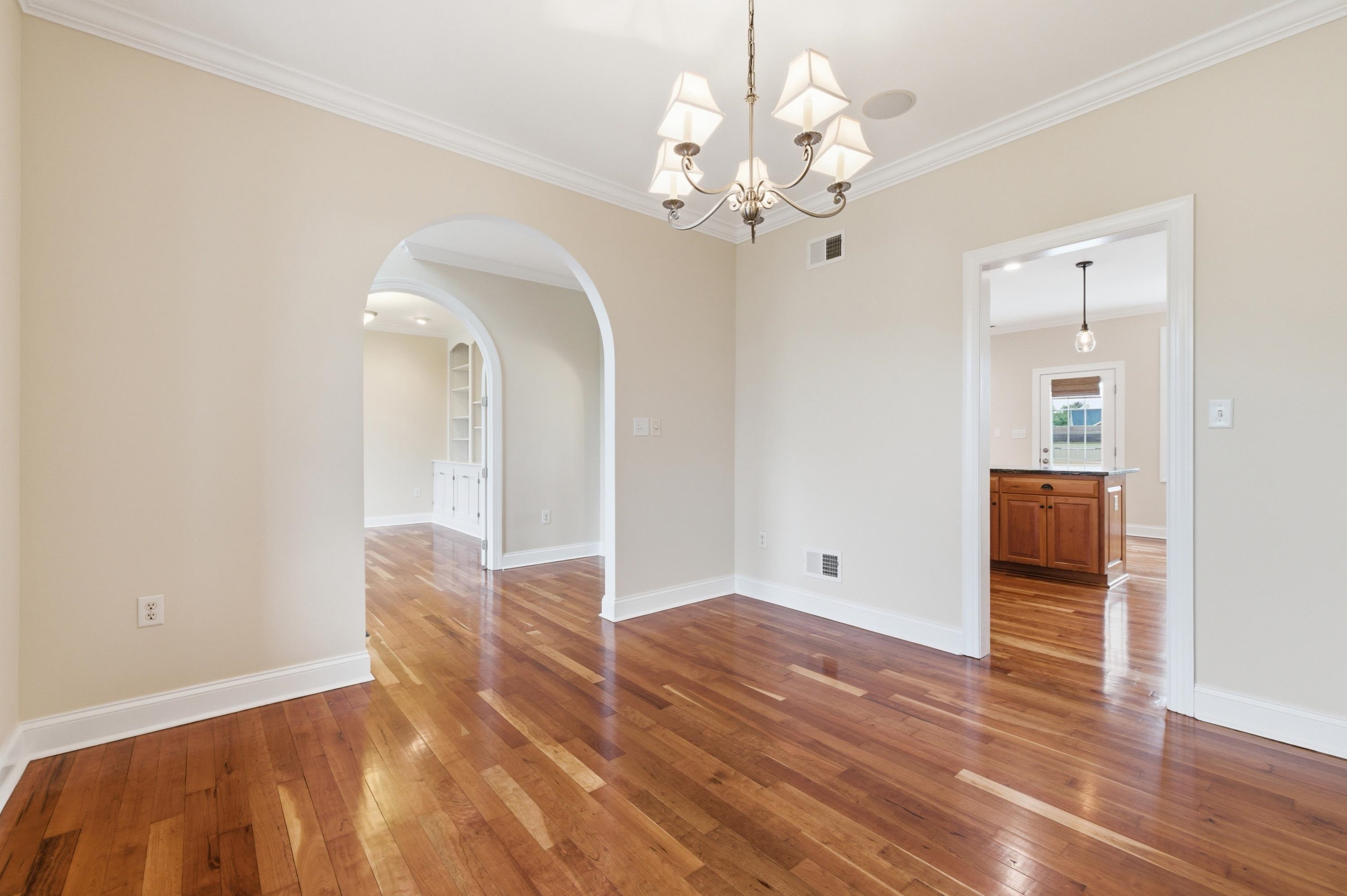 2625 Rising Rock Court Harrisonburg, VA 22802 - Photo 19 of 73 The dining room offers large windows throughout, chandelier, hardwood flooring throughout the space, and plenty of space for a table and chairs set.