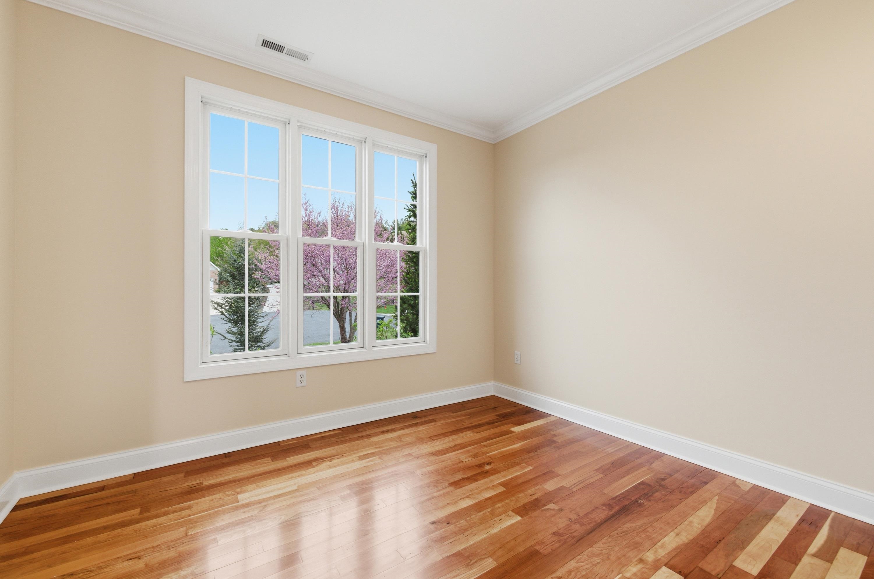 2625 Rising Rock Court Harrisonburg, VA 22802 - Photo 22 of 73 Off the foyer space is a beautiful room featuring a lot of built-in shelving. This room offers hardwood flooring throughout, large windows, and would be perfect for use as a home office or additional family room.