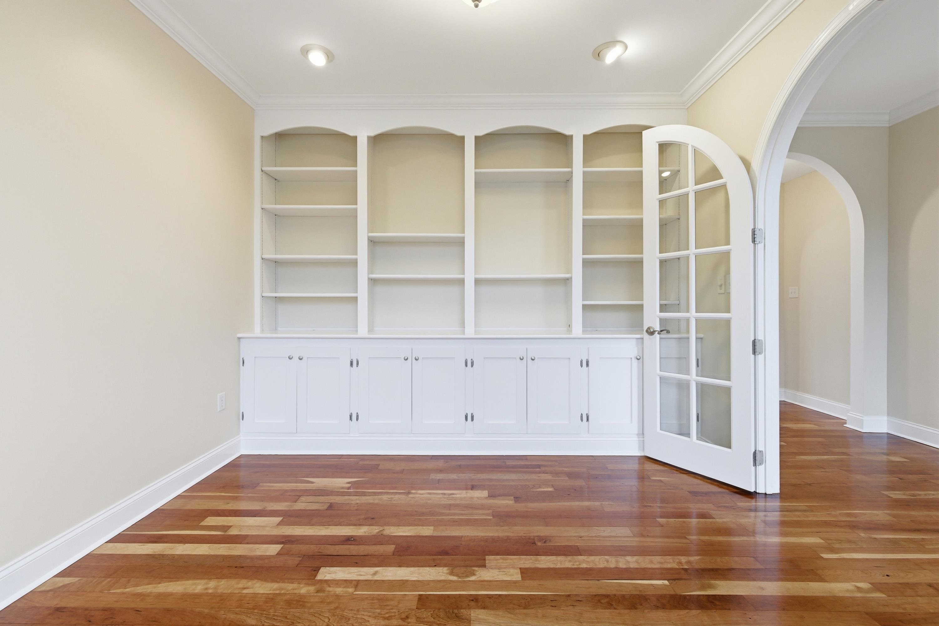 2625 Rising Rock Court Harrisonburg, VA 22802 - Photo 23 of 73 Off the foyer space is a beautiful room featuring a lot of built-in shelving. This room offers hardwood flooring throughout, large windows, and would be perfect for use as a home office or additional family room.