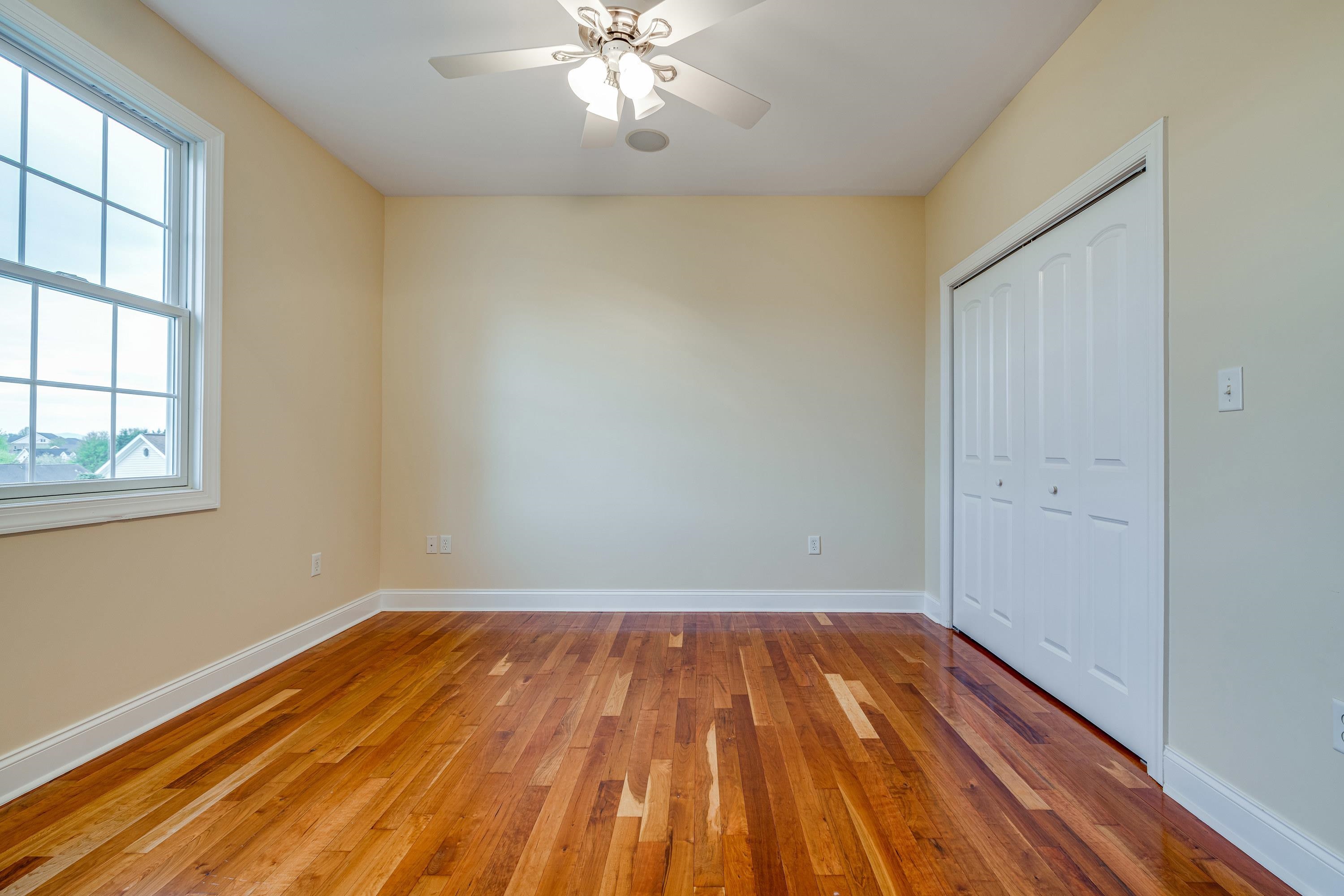 2625 Rising Rock Court Harrisonburg, VA 22802 - Photo 45 of 73 An additional bedroom is located on the main level of the home and features a spacious closet, hardwood flooring throughout, ceiling fan, large windows, and more!