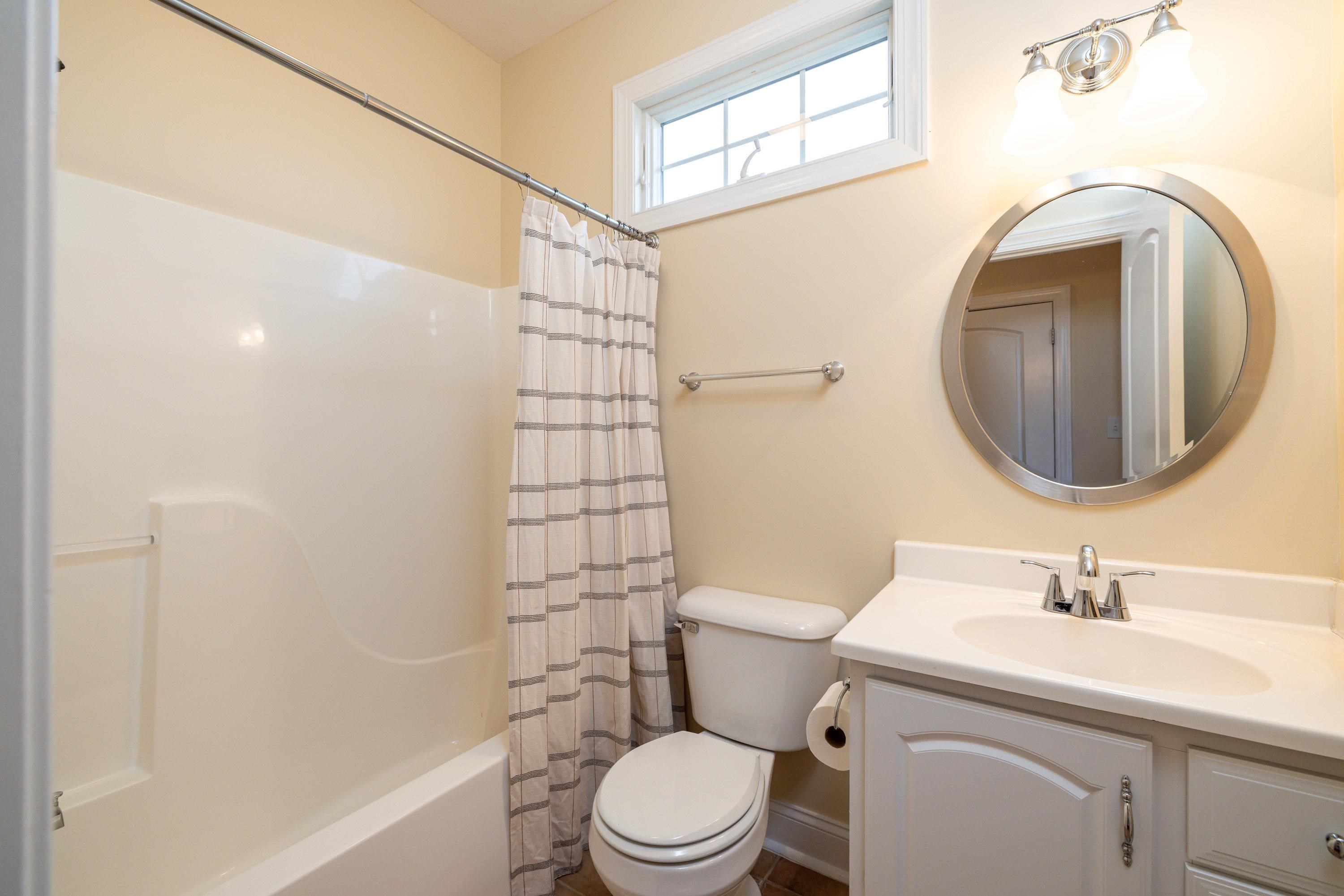 2625 Rising Rock Court Harrisonburg, VA 22802 - Photo 48 of 73 This third bathroom is located on the main level of the home and features a full bathtub/shower combination, vanity with storage, and more!