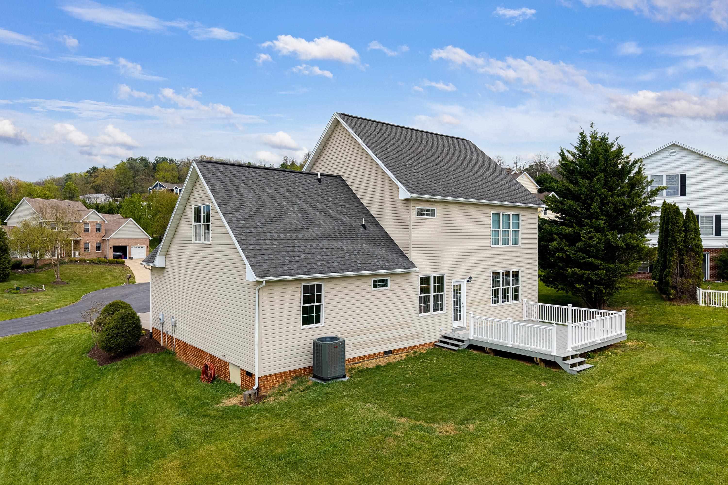 2625 Rising Rock Court Harrisonburg, VA 22802 - Photo 57 of 73 The rear view of the home highlights the mature yard, large deck with vinyl railings, mostly-level lot, and storage building.