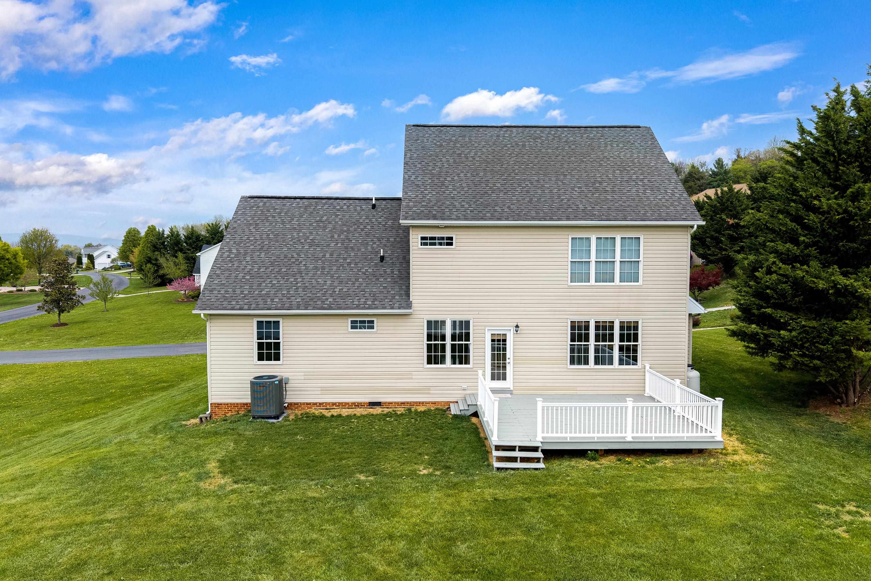 2625 Rising Rock Court Harrisonburg, VA 22802 - Photo 58 of 73 The rear view of the home highlights the mature yard, large deck with vinyl railings, mostly-level lot, and storage building.