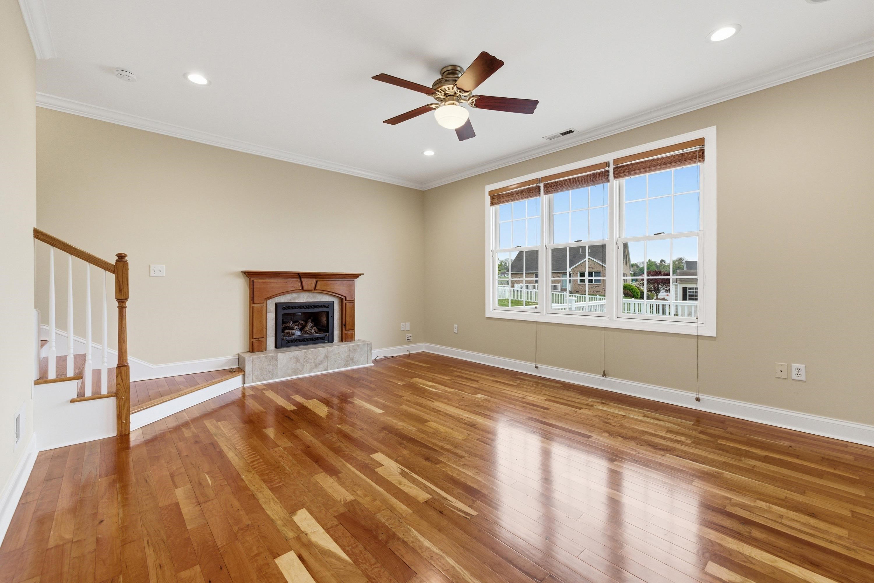 2625 Rising Rock Court Harrisonburg, VA 22802 - Photo 9 of 73 The living room space is large and offers hardwood flooring throughout, large windows allowing in an abundance of natural light, gas fireplace, and plenty of room for gathering with family and friends.