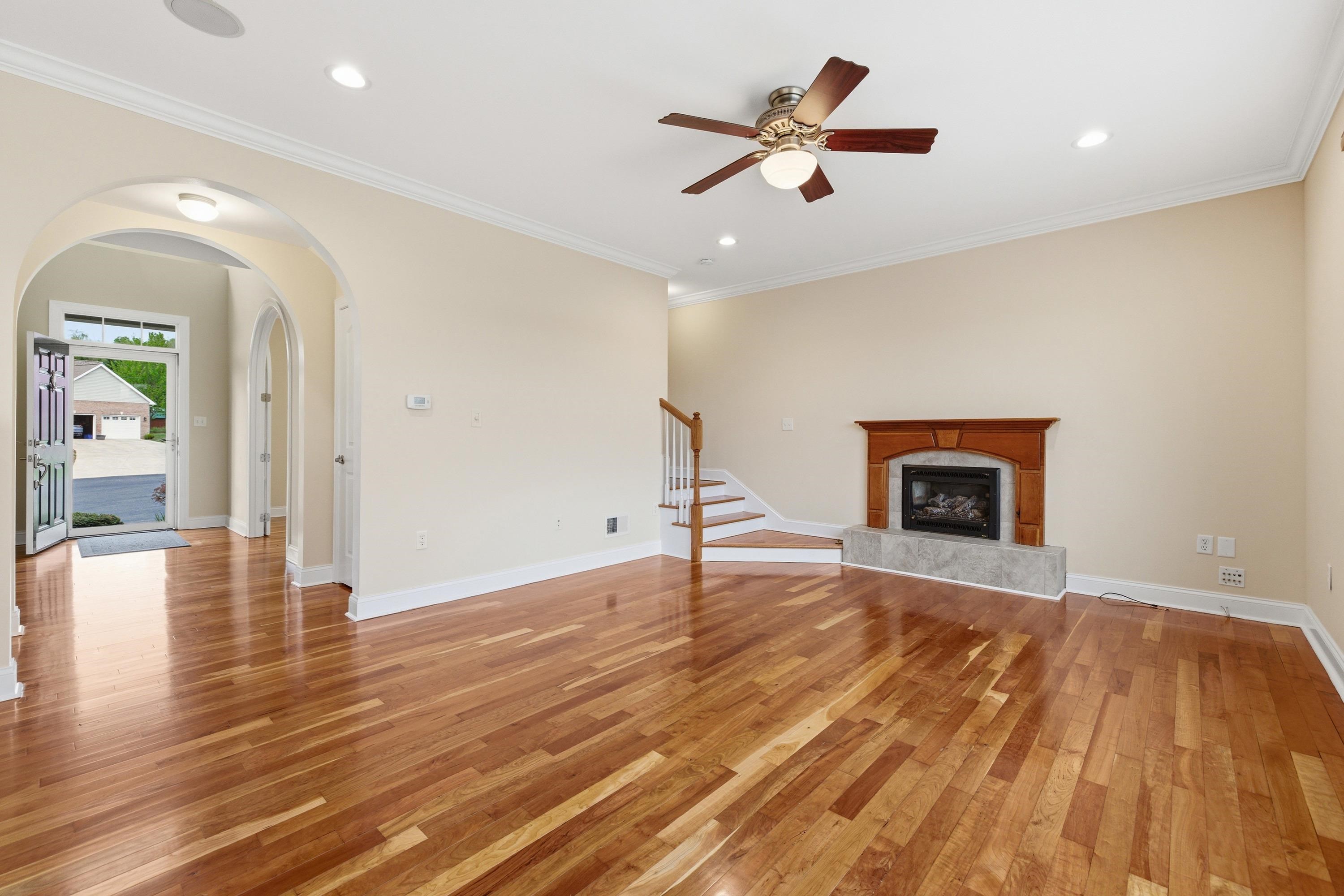 2625 Rising Rock Court Harrisonburg, VA 22802 - Photo 10 of 73 The living room space is large and offers hardwood flooring throughout, large windows allowing in an abundance of natural light, gas fireplace, and plenty of room for gathering with family and friends.