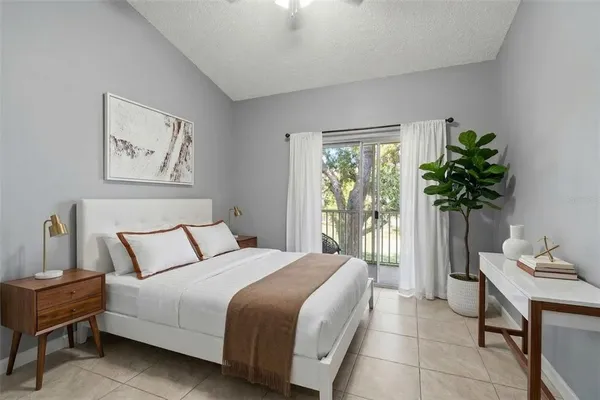 a bedroom with a bed and a potted plant