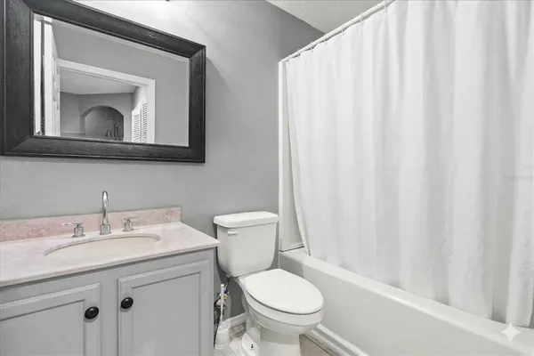 a bathroom with a toilet a sink and a mirror
