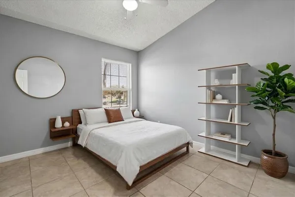 a bedroom with a bed and a potted plant