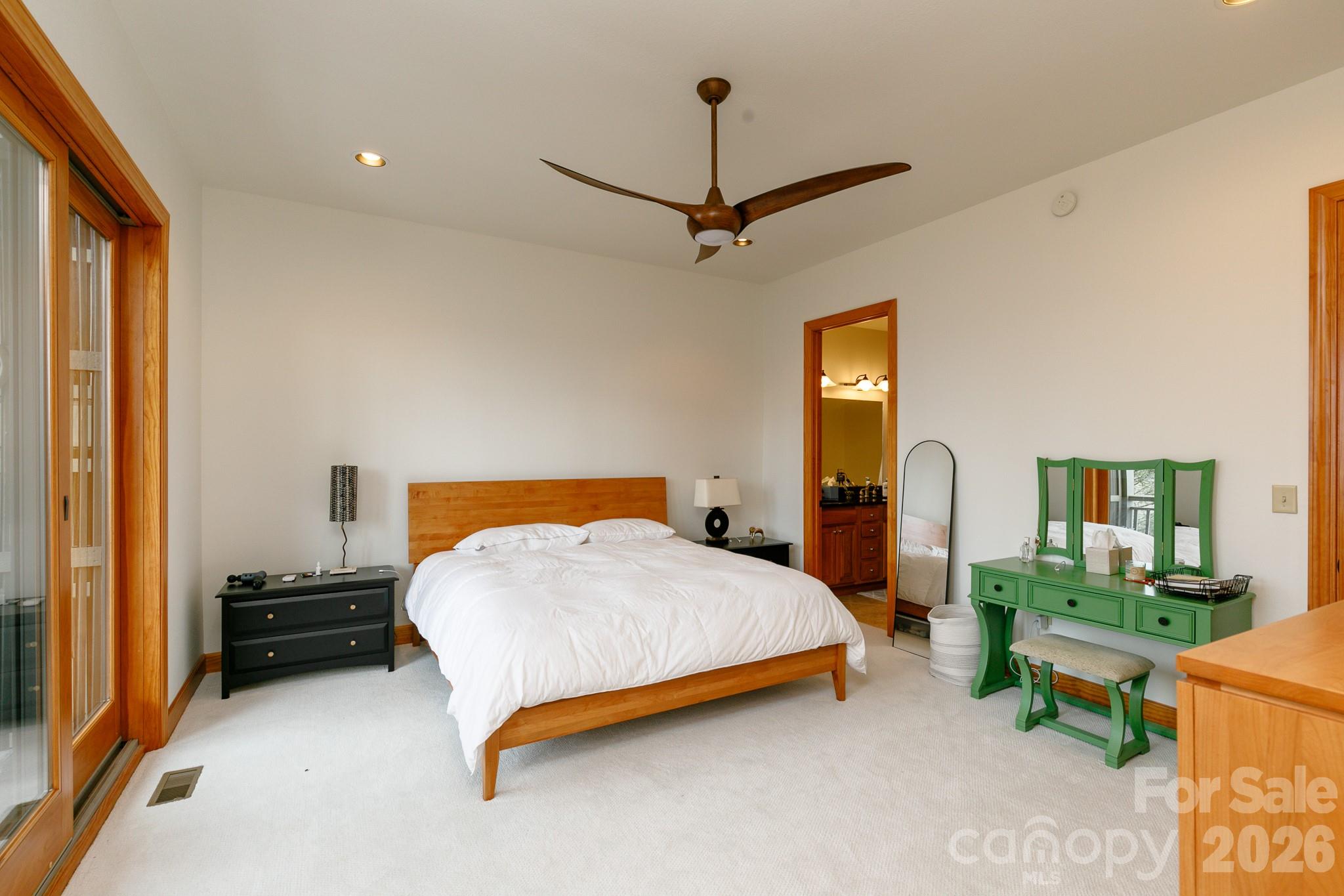 528 Andrew Banks Road, Unit A/3 Burnsville, NC 28714 - Photo 12 of 30 a bedroom with a bed a table and painting