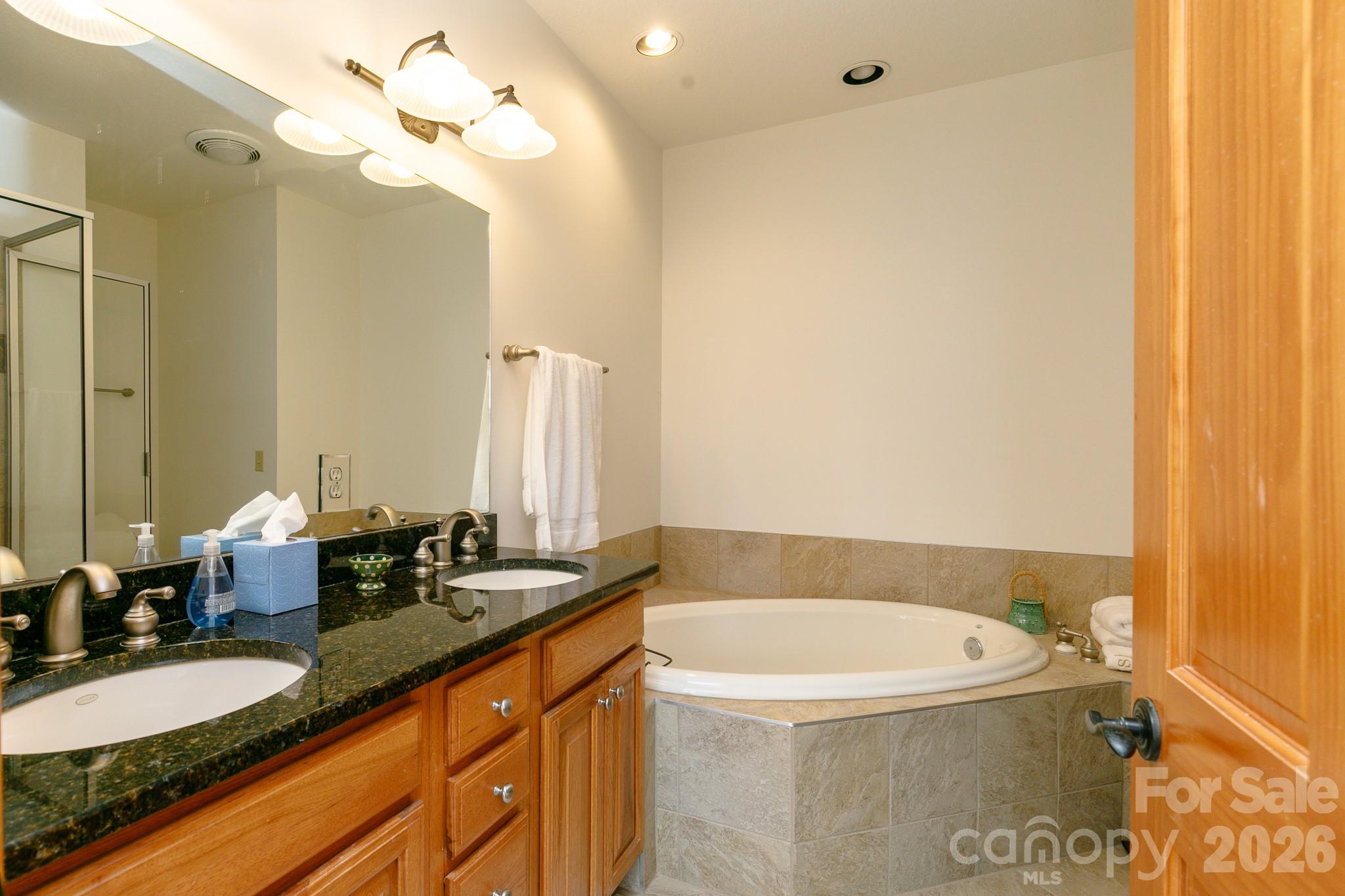 528 Andrew Banks Road, Unit A/3 Burnsville, NC 28714 - Photo 14 of 30 a bathroom with a granite countertop sink and a mirror