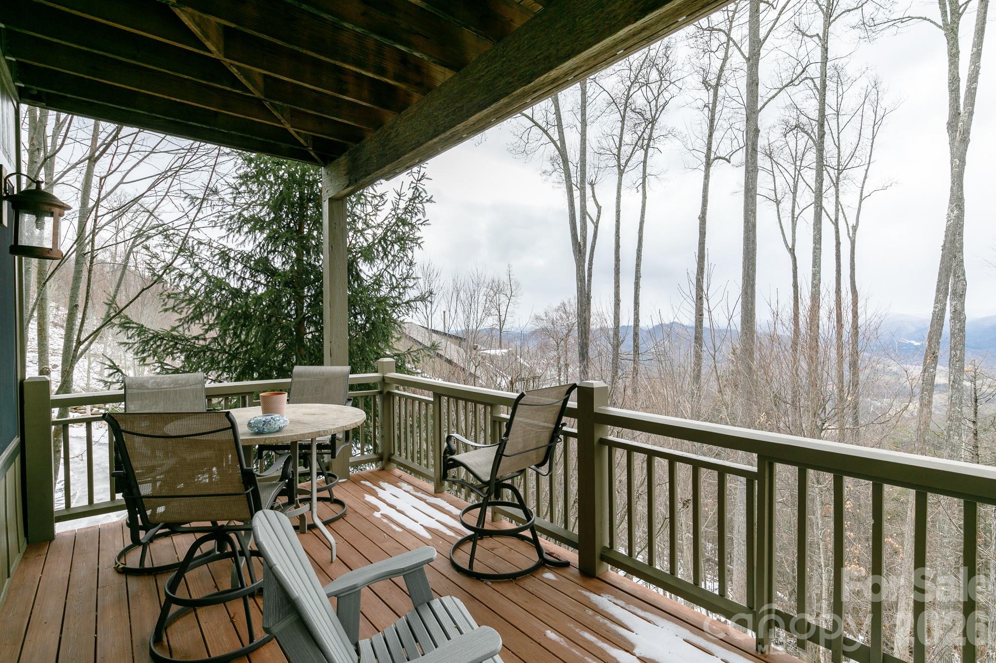 528 Andrew Banks Road, Unit A/3 Burnsville, NC 28714 - Photo 16 of 30 a view of balcony with wooden floor and outdoor seating
