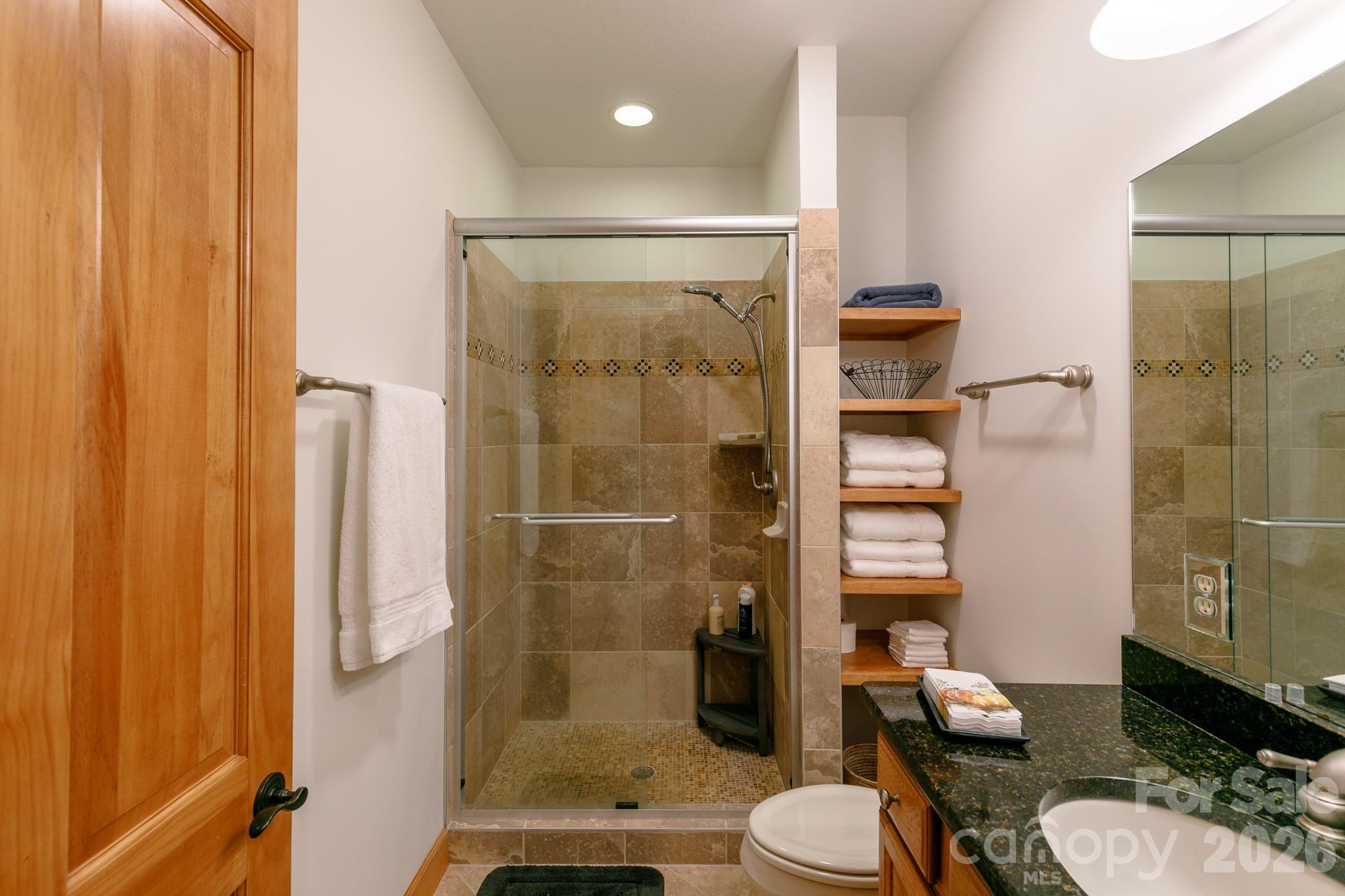528 Andrew Banks Road, Unit A/3 Burnsville, NC 28714 - Photo 22 of 30 a bathroom with a sink toilet and shower