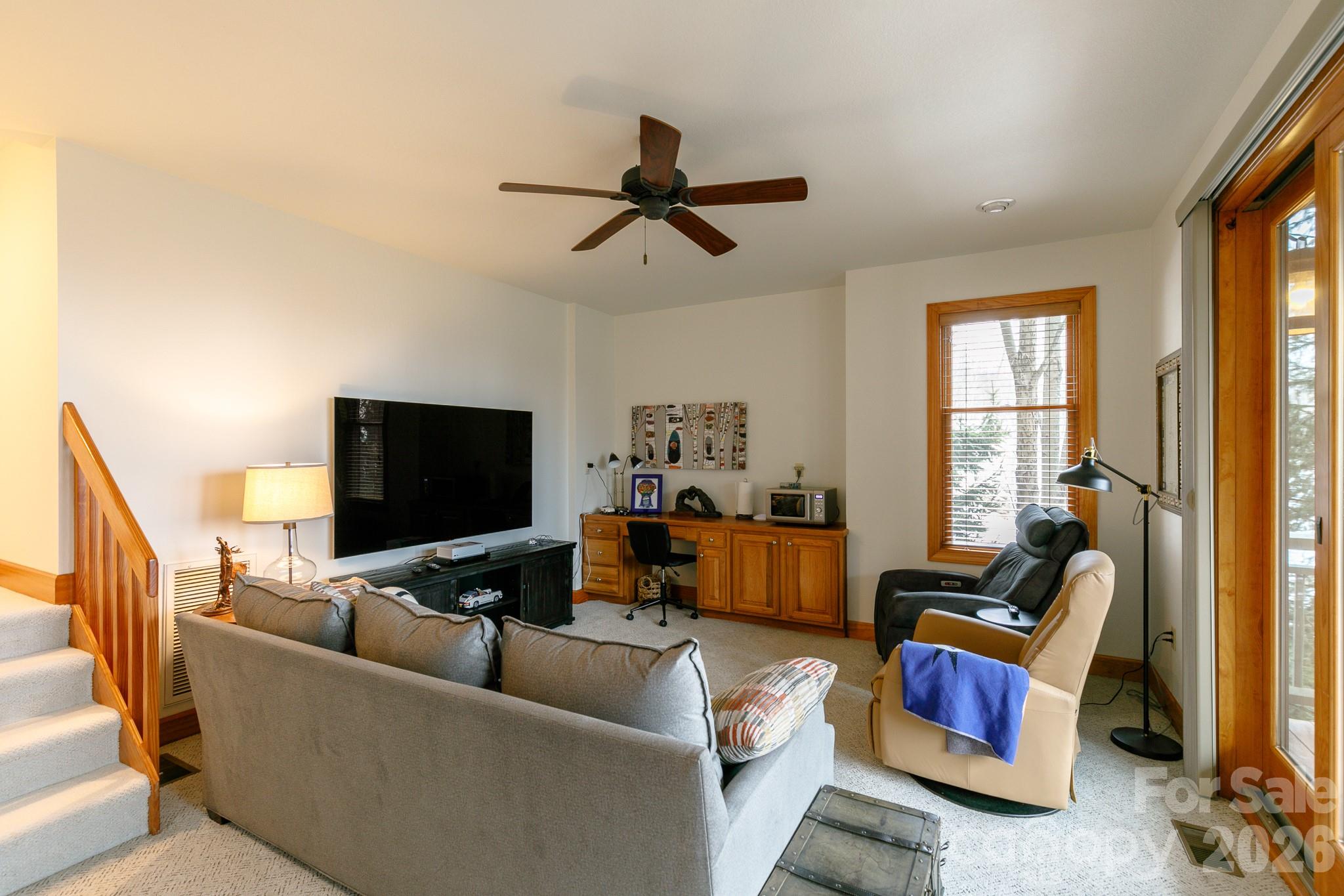 528 Andrew Banks Road, Unit A/3 Burnsville, NC 28714 - Photo 23 of 30 a living room with furniture and a flat screen tv