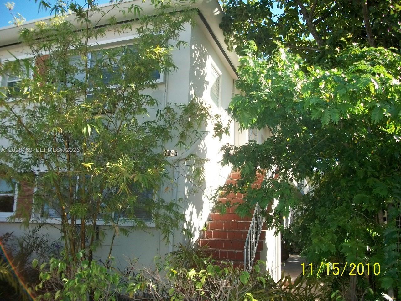 7035 Rue Granville, Unit 2 Miami Beach, FL 33141 - Photo 5 of 6 a backyard of a house with lots of green space and plants