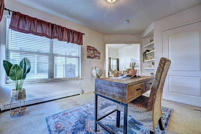 a view of a workspace with furniture and a potted plant