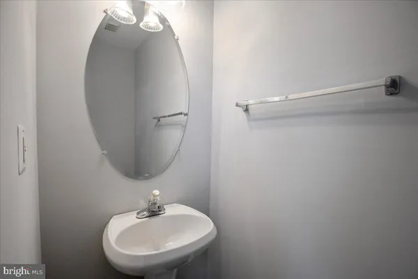 a bathroom with a sink and mirror