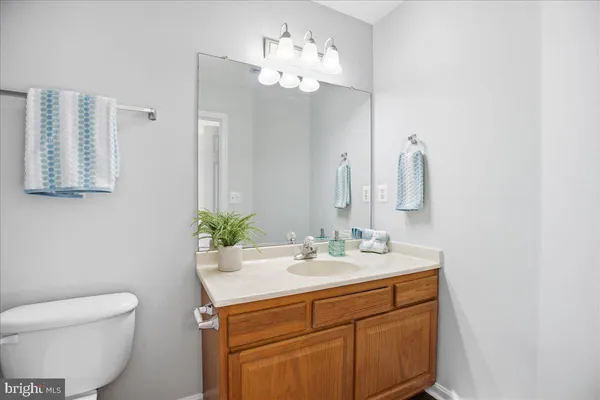 a bathroom with a toilet sink and mirror