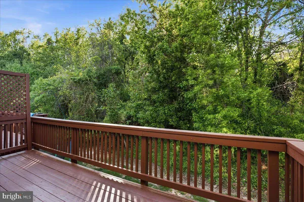 a view of balcony with wooden floor and fence