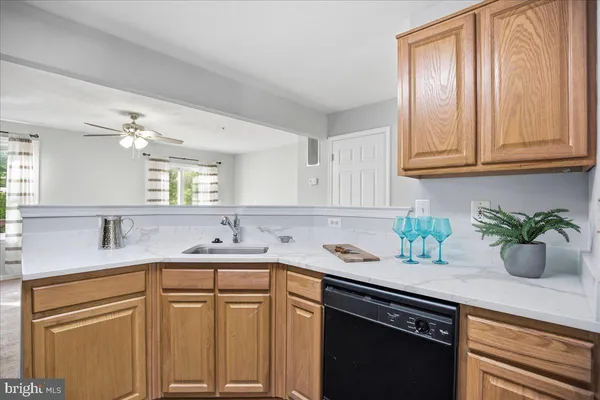 a kitchen with kitchen island granite countertop a sink stainless steel appliances and cabinets
