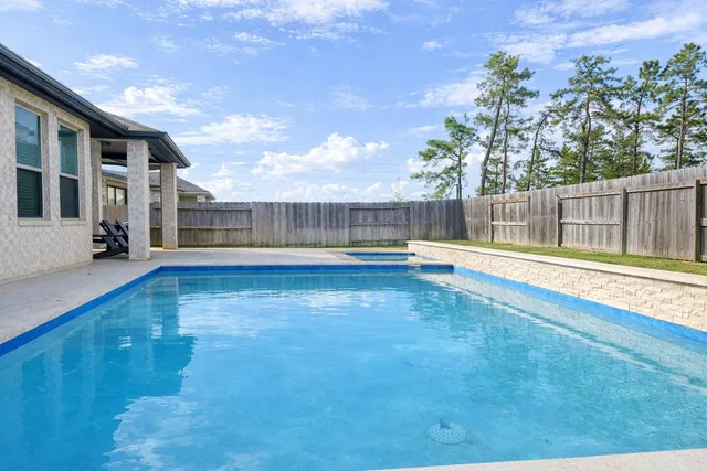 a swimming pool with wooden fence