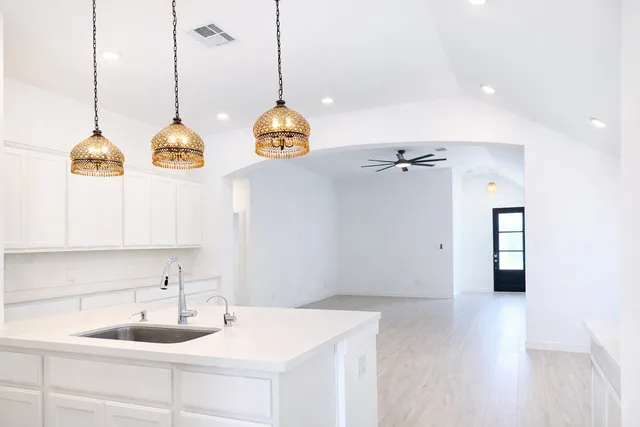 a bathroom with a sink a mirror and vanity