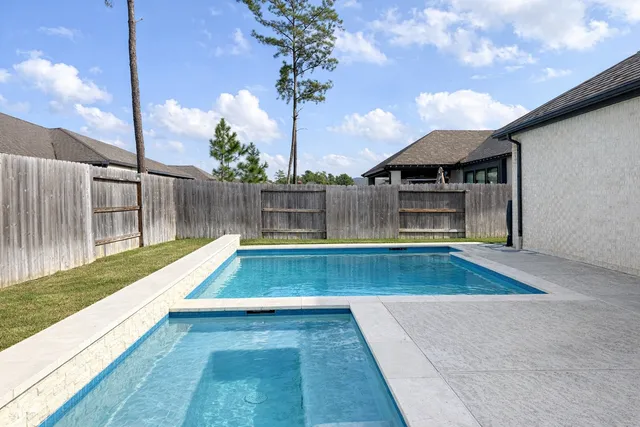 a view of swimming pool with a patio